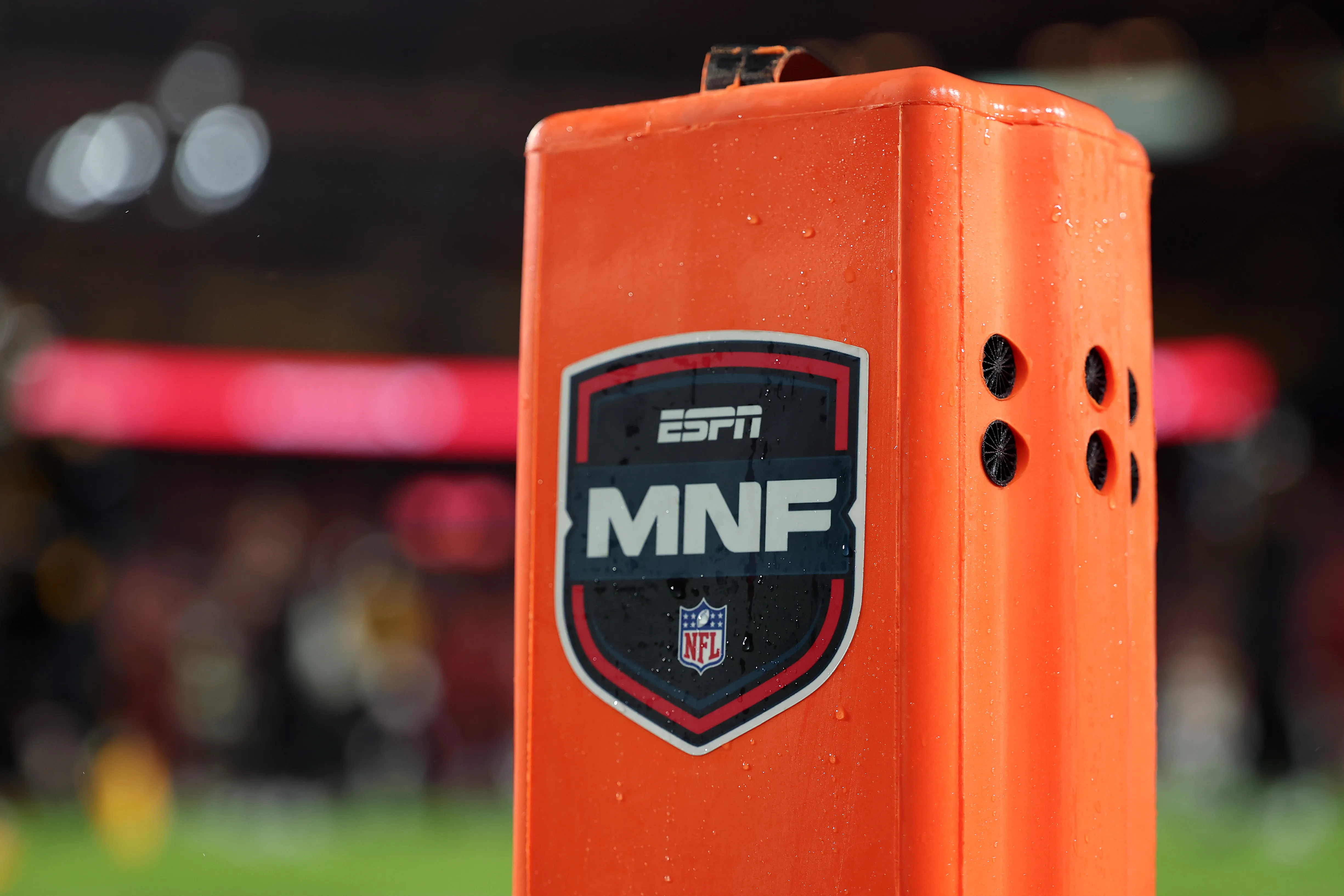 迪士尼与ESPN标志在屏幕上显示，背景为股市数据分析图