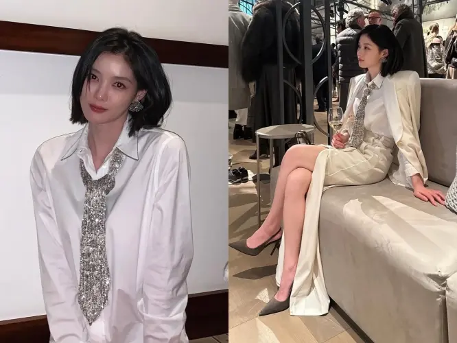 金裕贞身穿米白色西装外套搭在肩上,展现职场女性的干练与优雅